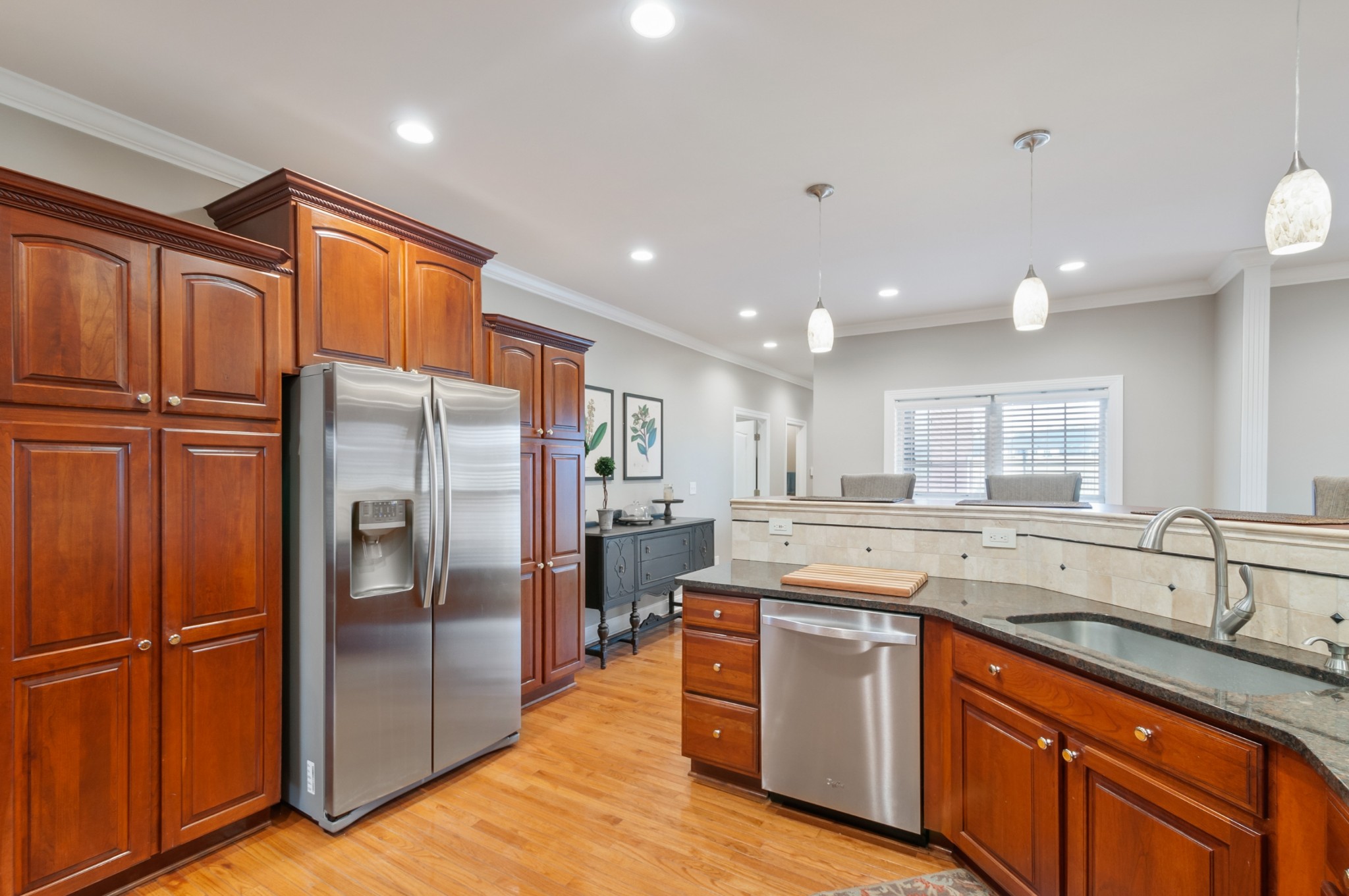 876 Baker Road Columbia, TN 38401 - Photo 11 of 48 a kitchen with stainless steel appliances granite countertop a refrigerator a sink a stove and white cabinets with wooden floor