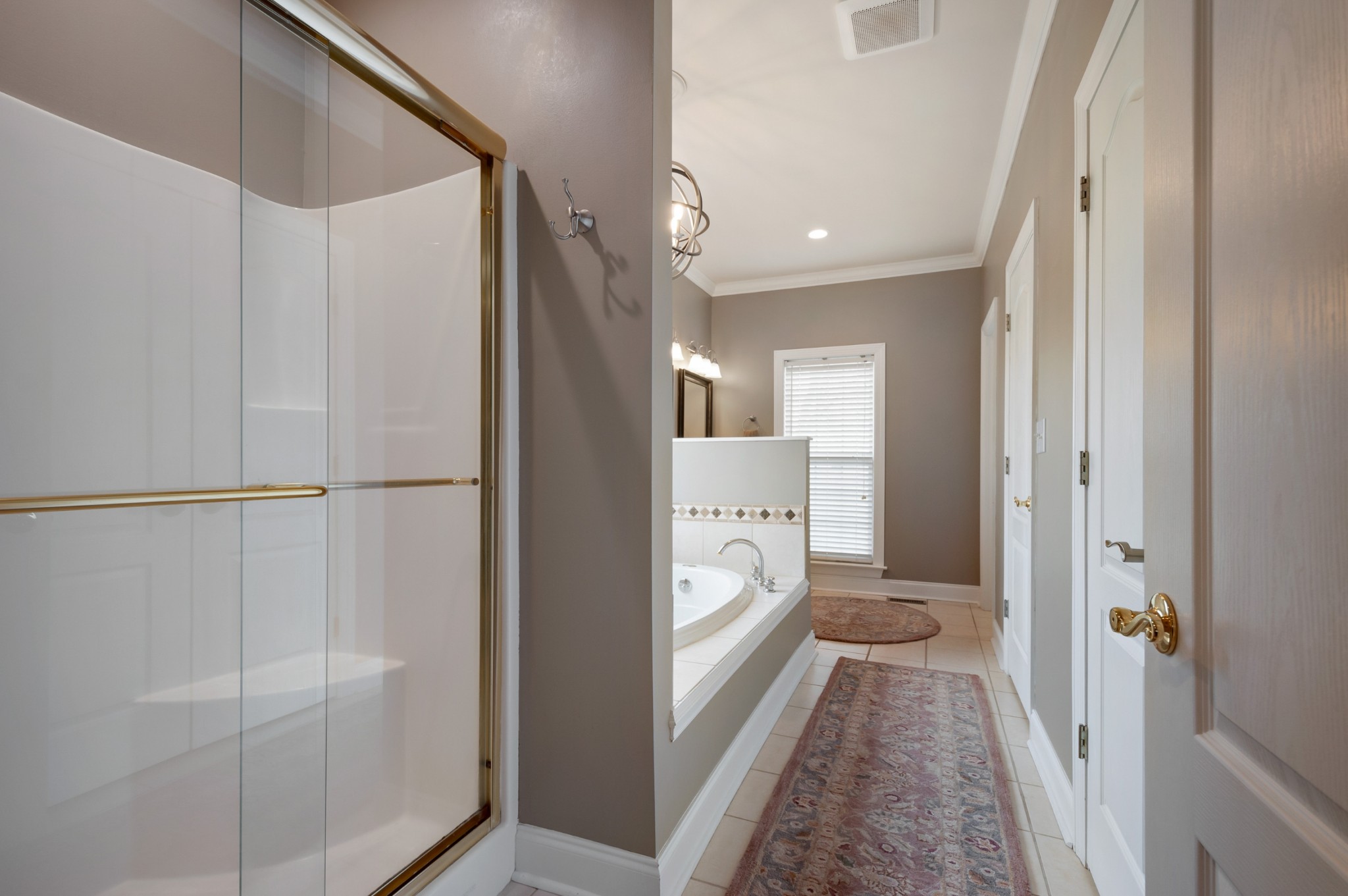 876 Baker Road Columbia, TN 38401 - Photo 21 of 48 a walk in closet with wooden floor and bathroom