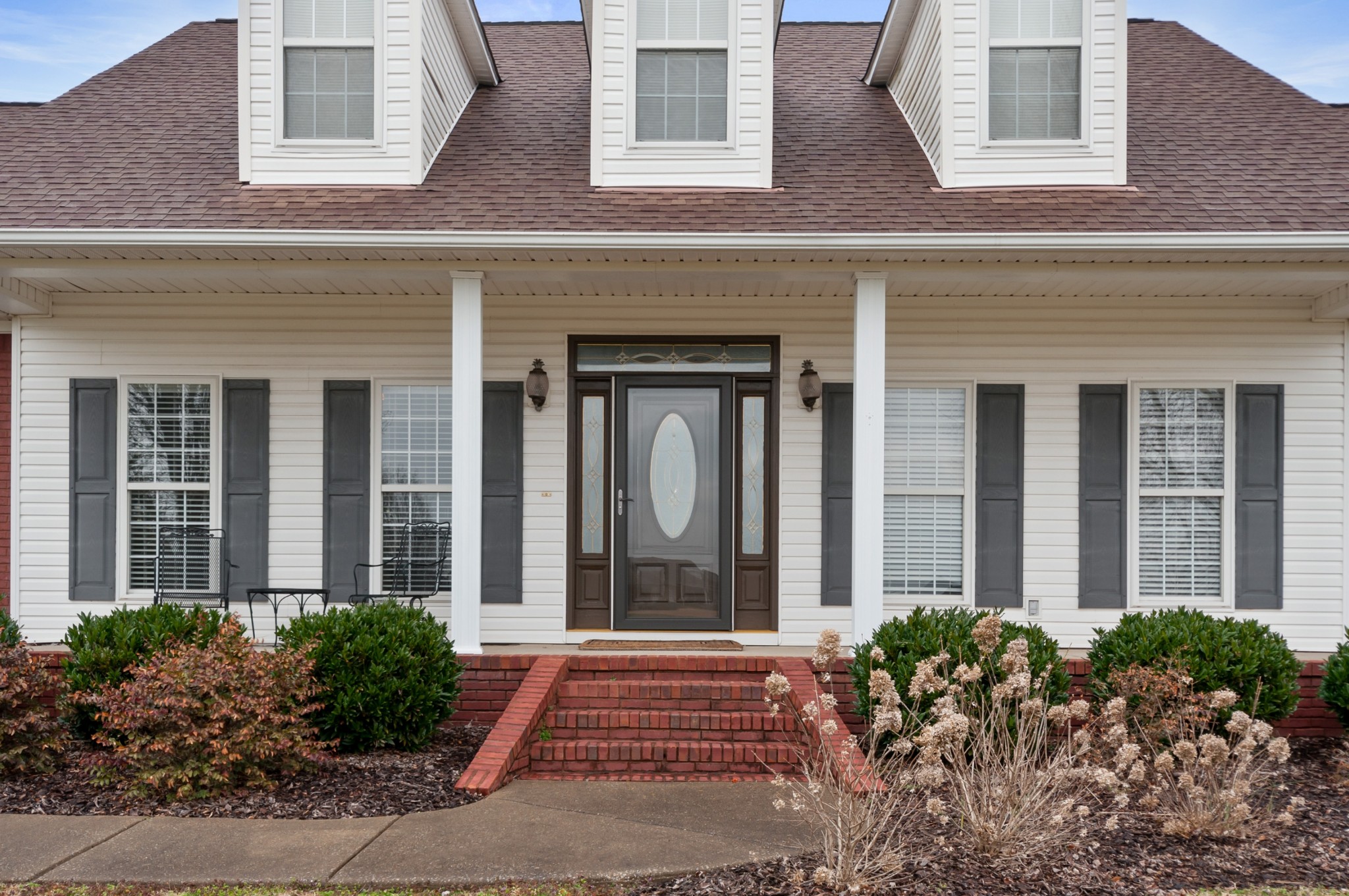 876 Baker Road Columbia, TN 38401 - Photo 3 of 48 front view of a brick house many windows and potted plants