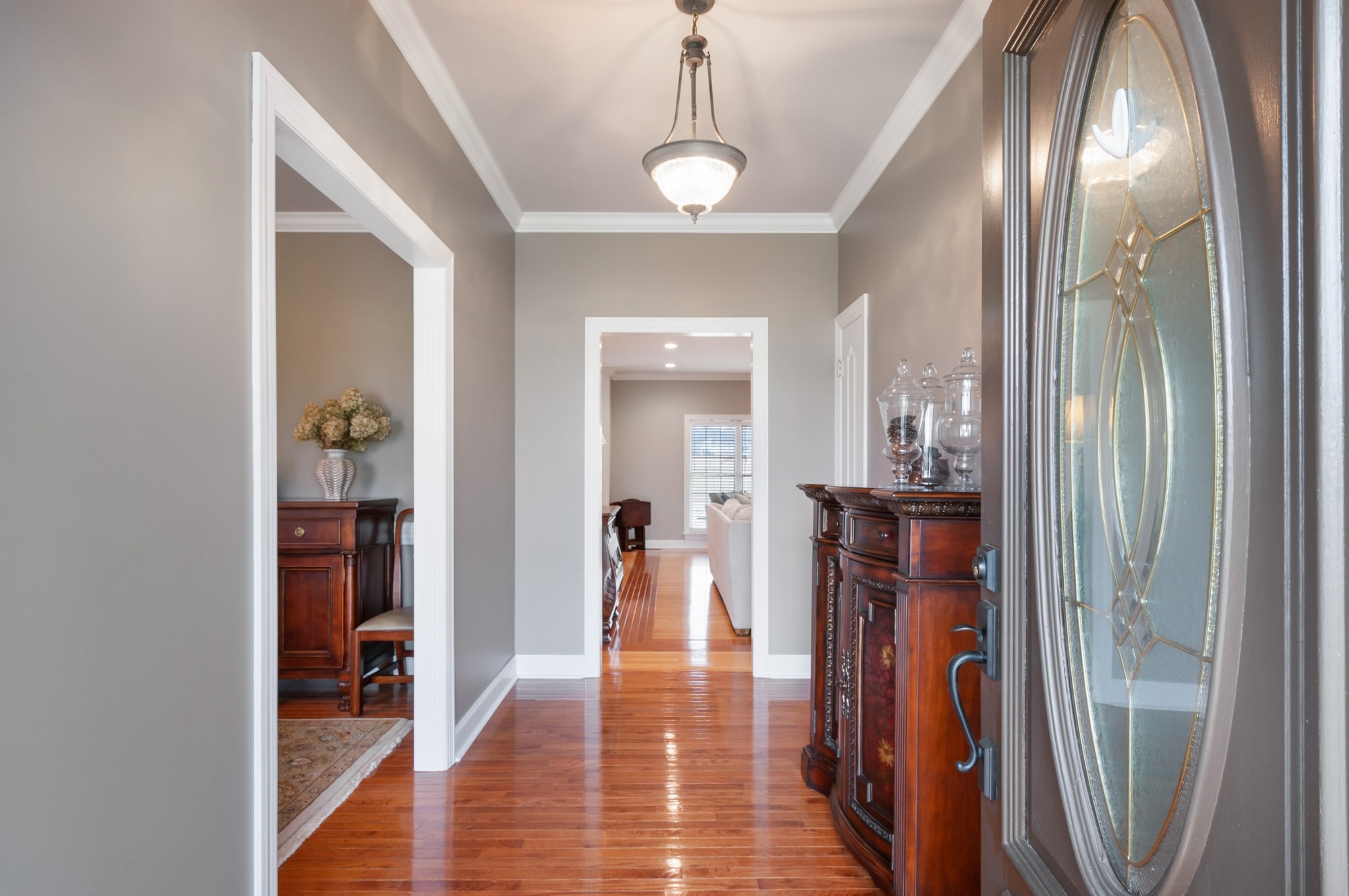876 Baker Road Columbia, TN 38401 - Photo 6 of 48 a view of a hallway with wooden floor and a livingroom with furniture