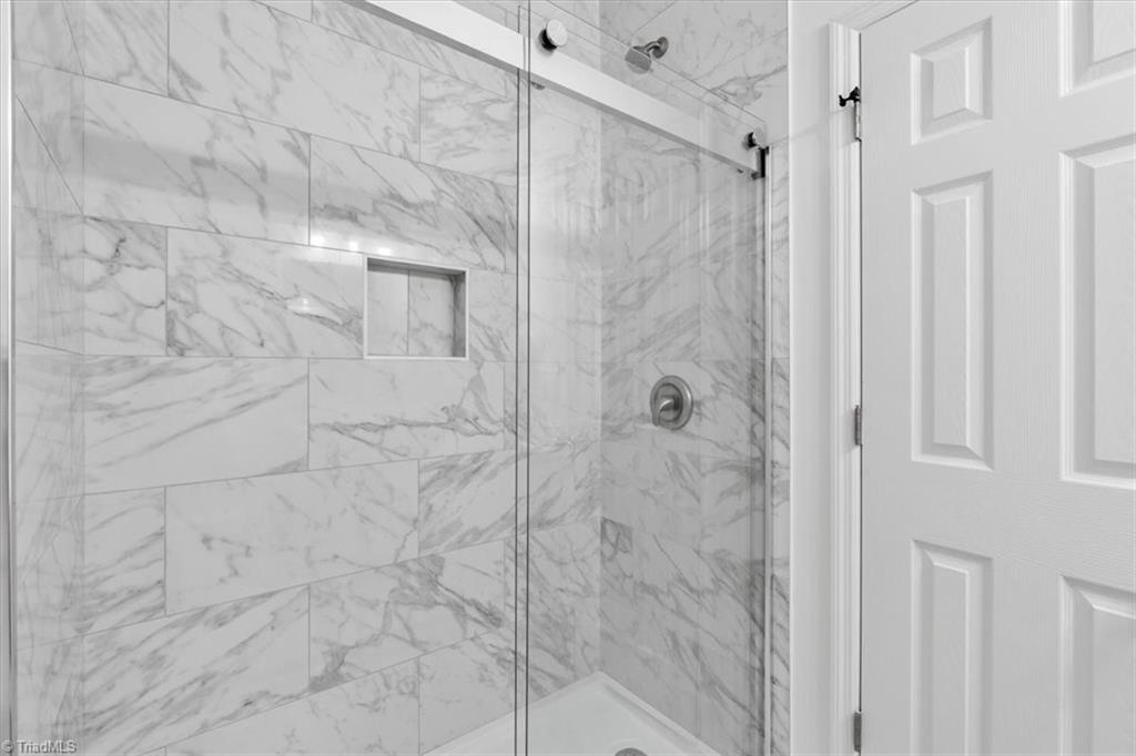 1622 Rankin Road Greensboro, NC 27405 - Photo 11 of 23 Walk-in shower w/ sliding glass door and tile that goes to the ceiling in this walk in shower on main level