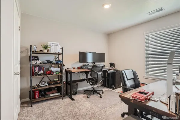 a kitchen with a refrigerator a microwave oven a sink and a dining table with wooden floor