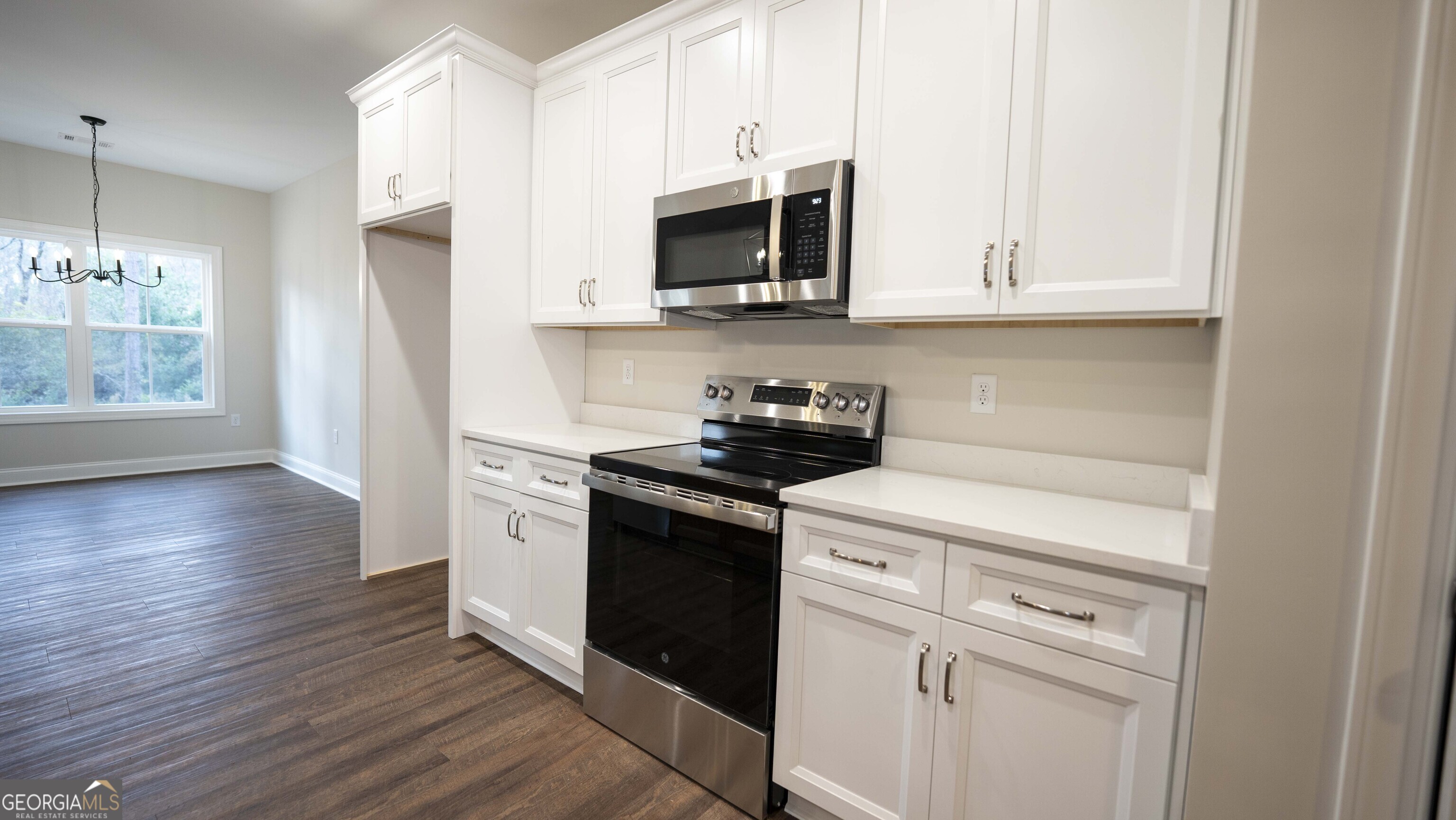 288 Frank Cook Road Cochran, GA 31014 - Photo 11 of 40 a kitchen with stainless steel appliances granite countertop a stove a microwave and a refrigerator