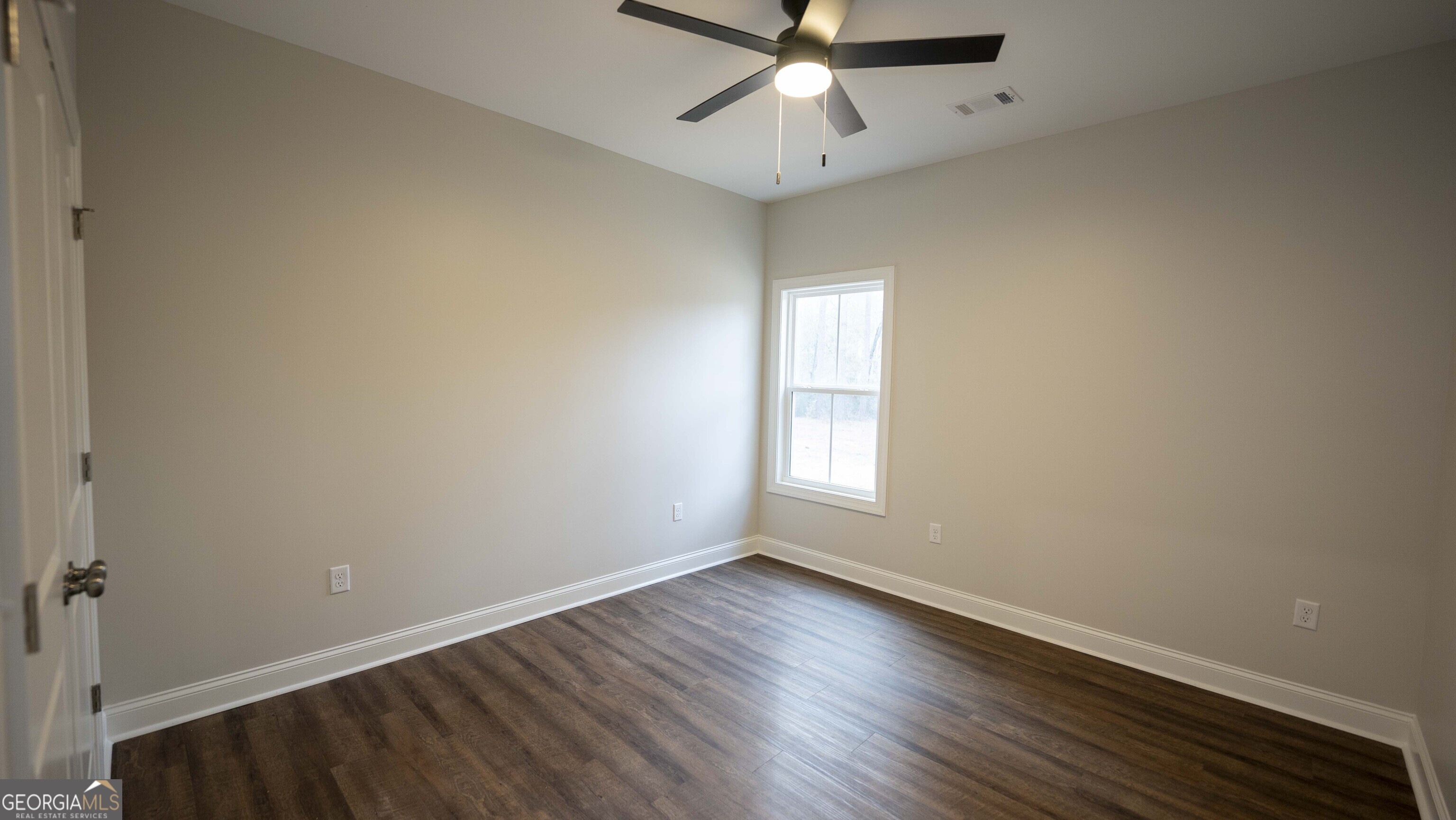 288 Frank Cook Road Cochran, GA 31014 - Photo 19 of 40 wooden floor in an empty room with a window