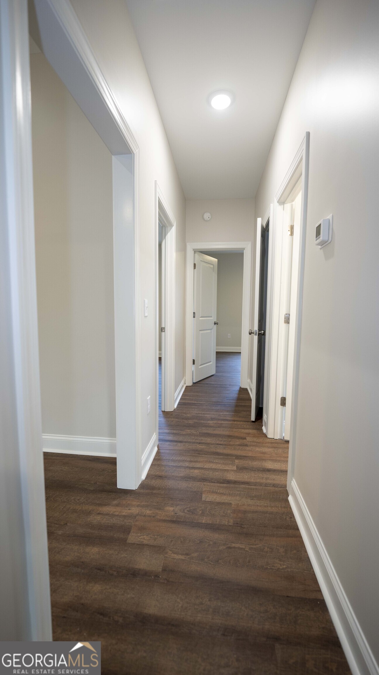 288 Frank Cook Road Cochran, GA 31014 - Photo 21 of 40 a view of a hallway with wooden floor