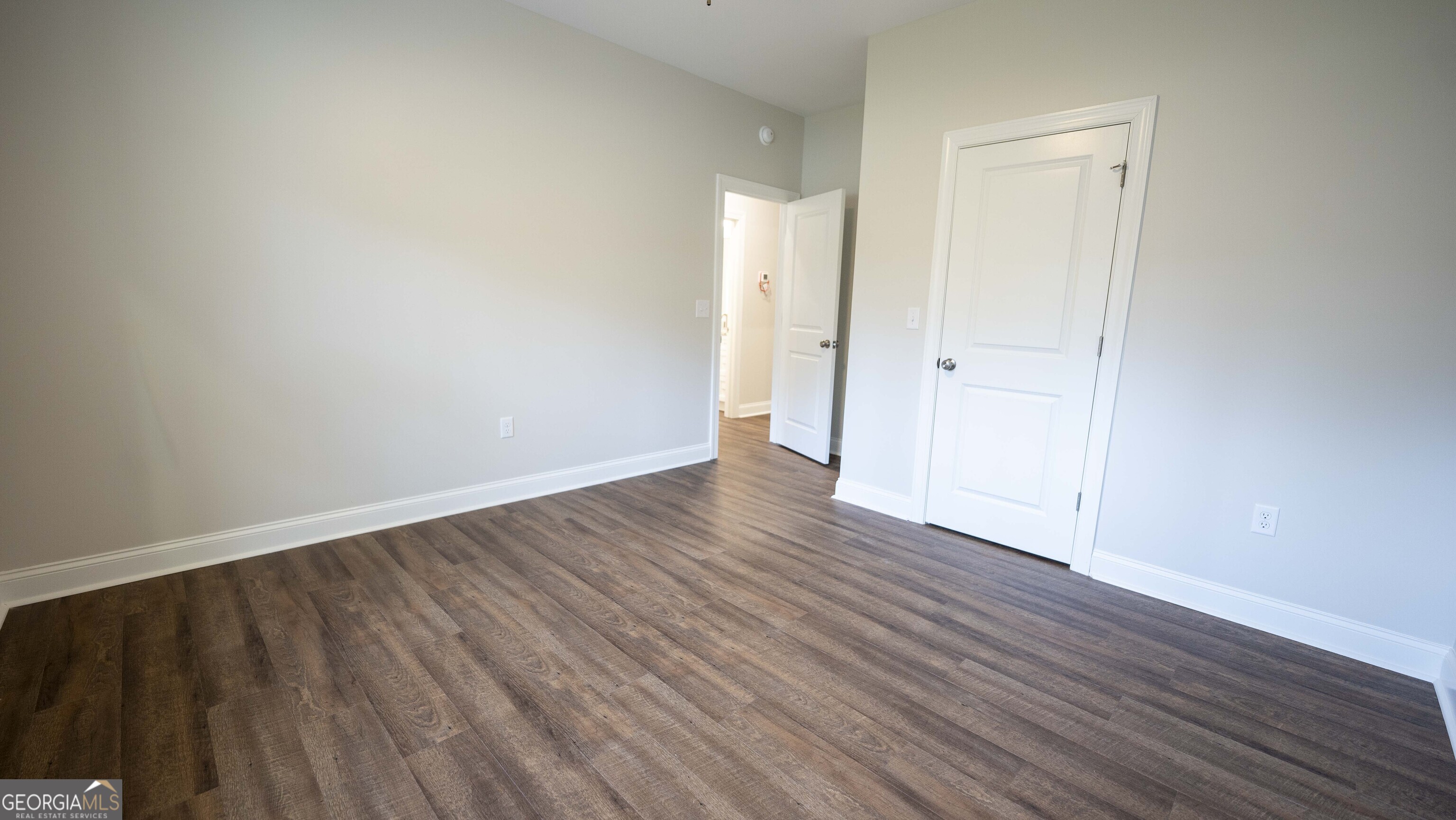 288 Frank Cook Road Cochran, GA 31014 - Photo 23 of 40 a view of an empty room with wooden floor and a window