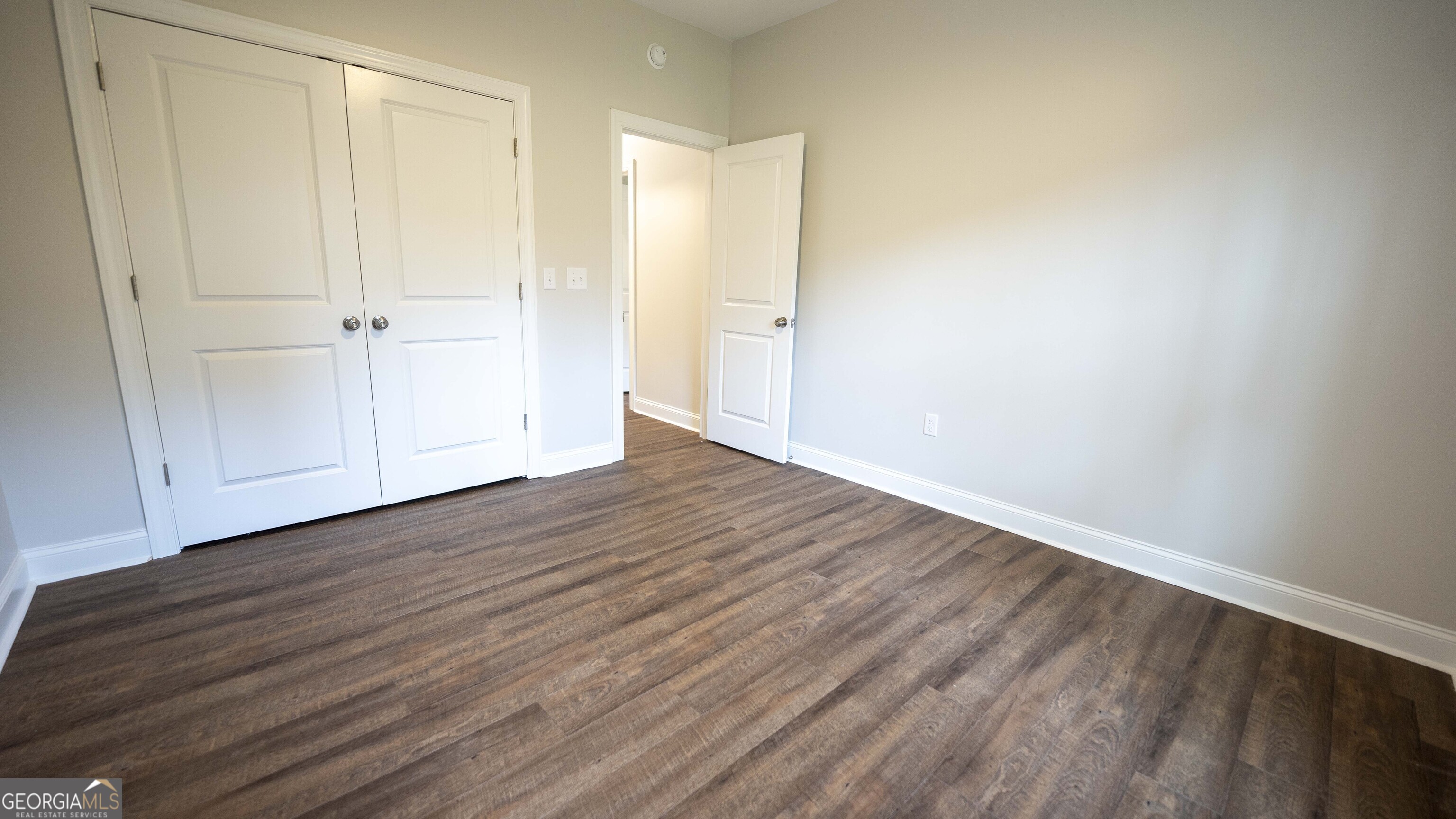 288 Frank Cook Road Cochran, GA 31014 - Photo 25 of 40 a view of an empty room with wooden floor