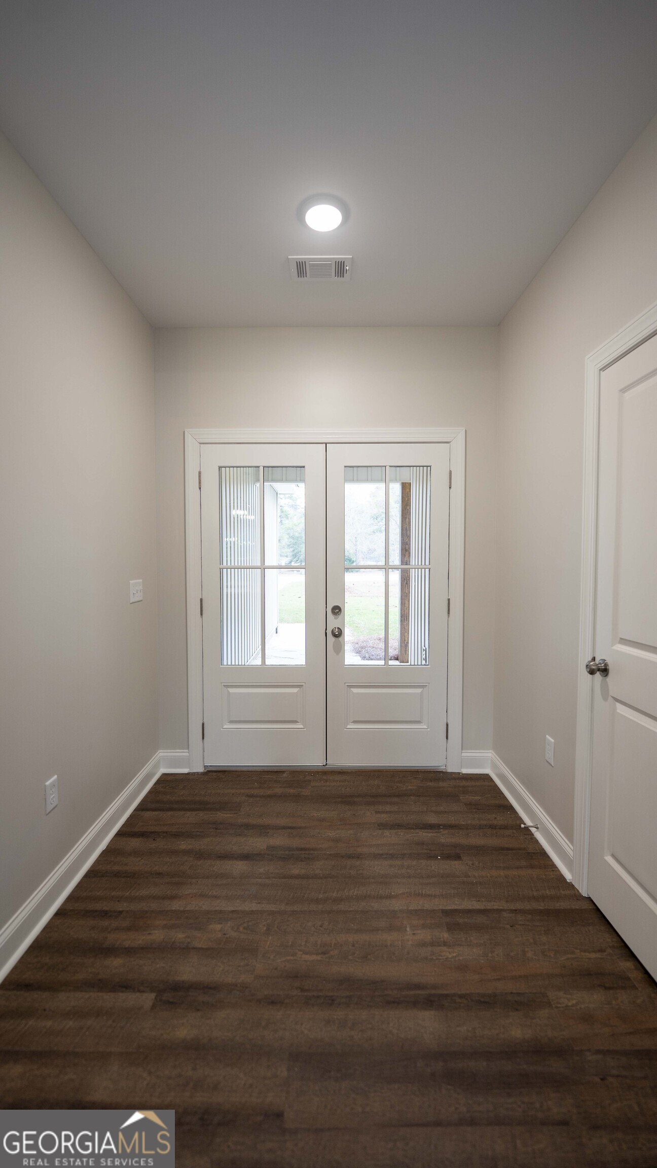 288 Frank Cook Road Cochran, GA 31014 - Photo 3 of 40 a view of empty room with wooden floor and fan