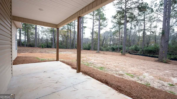 a view of a backyard of the house