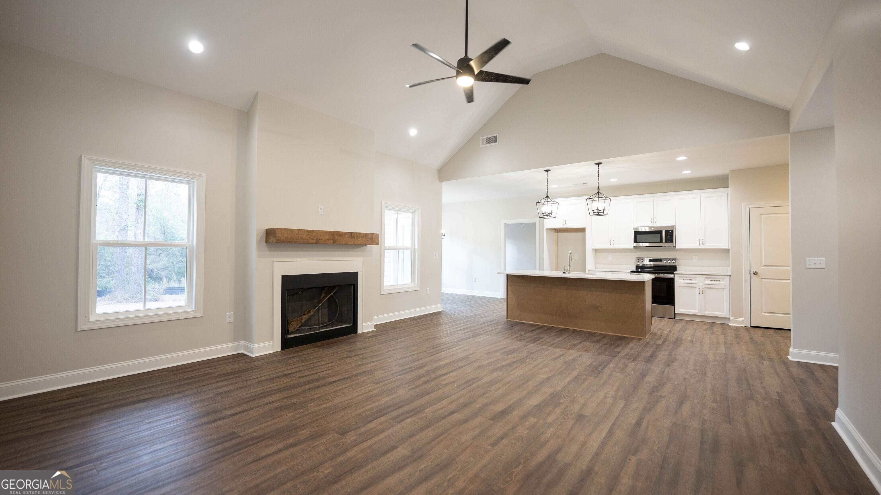 288 Frank Cook Road Cochran, GA 31014 - Photo 6 of 40 an open kitchen view with fireplace and wooden floor
