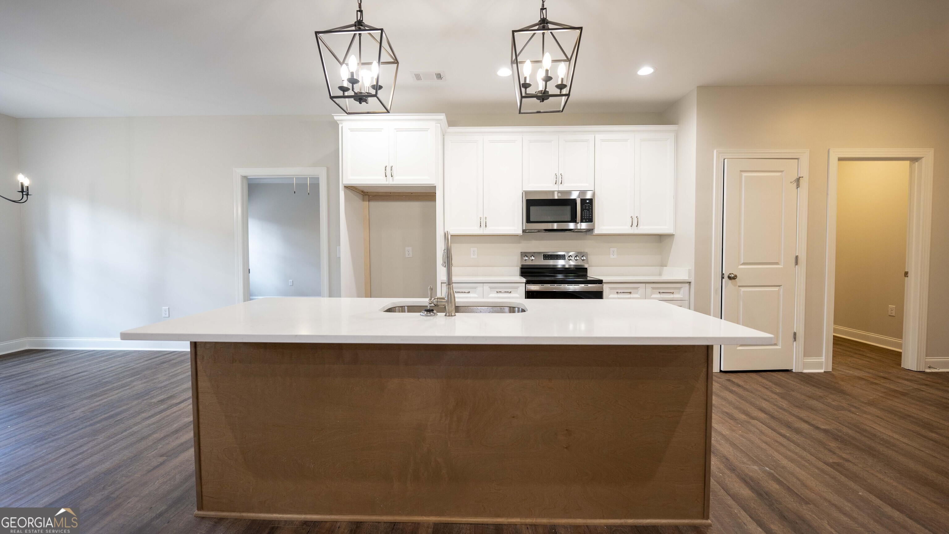 288 Frank Cook Road Cochran, GA 31014 - Photo 8 of 40 a kitchen with kitchen island stainless steel appliances a sink stove and wooden floor