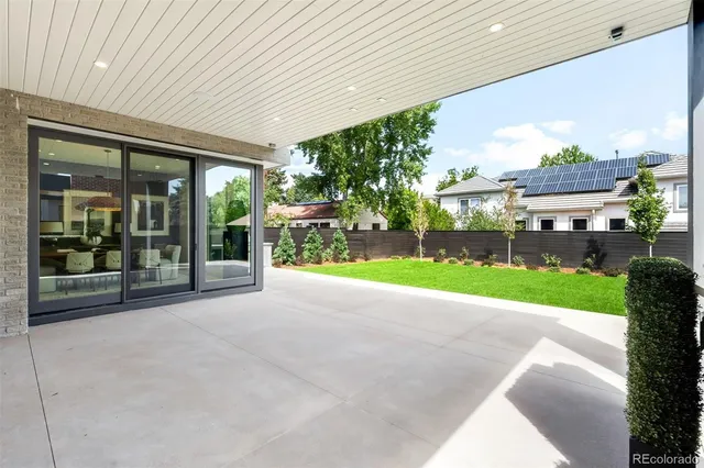 a view of a backyard with plants and a garden