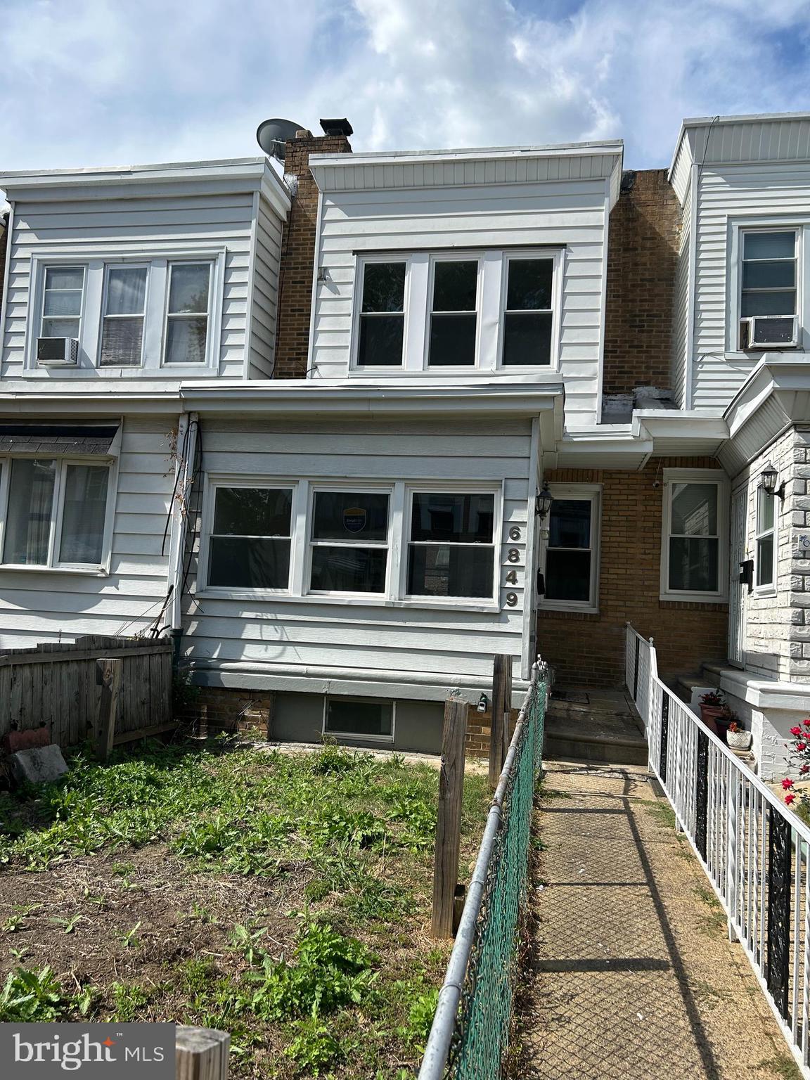 6849 Regent Street Philadelphia, PA 19142 - Photo 1 of 5 a front view of a house with a yard