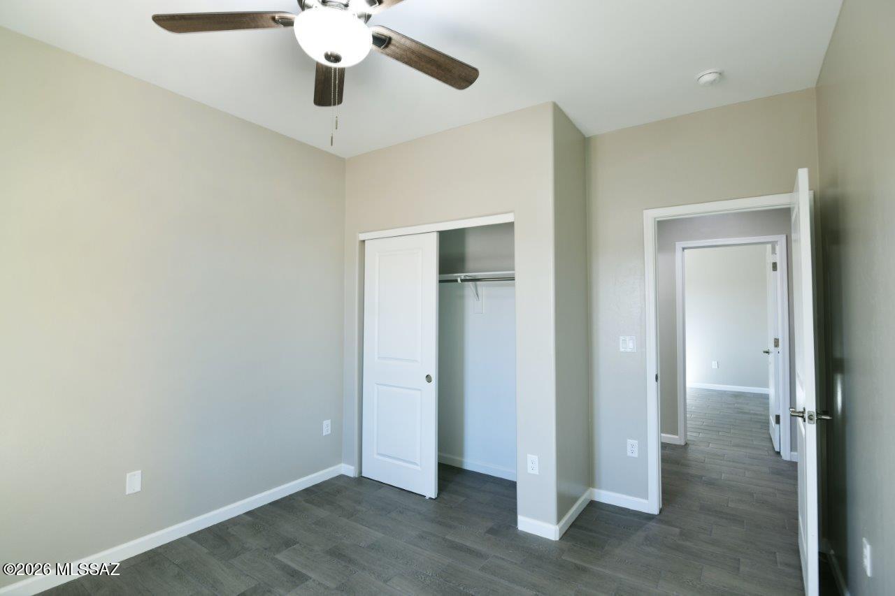 1091 North Vail View Road Vail, AZ 85641 - Photo 27 of 43 wooden floor in an empty room with a window
