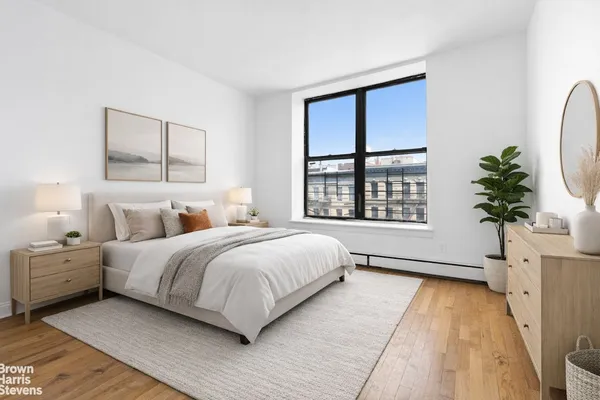 a bedroom with a large bed and a window