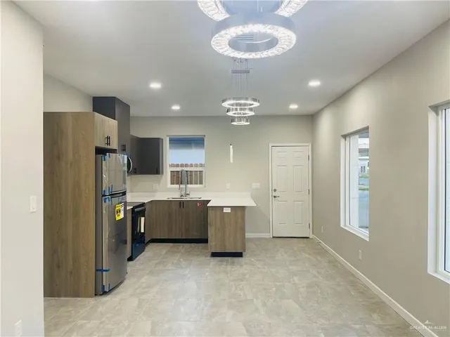 a kitchen with a refrigerator and a sink