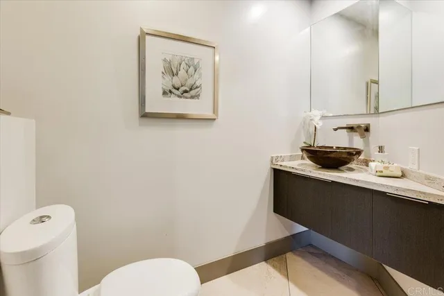 a bathroom with a granite countertop sink a toilet and bathtub