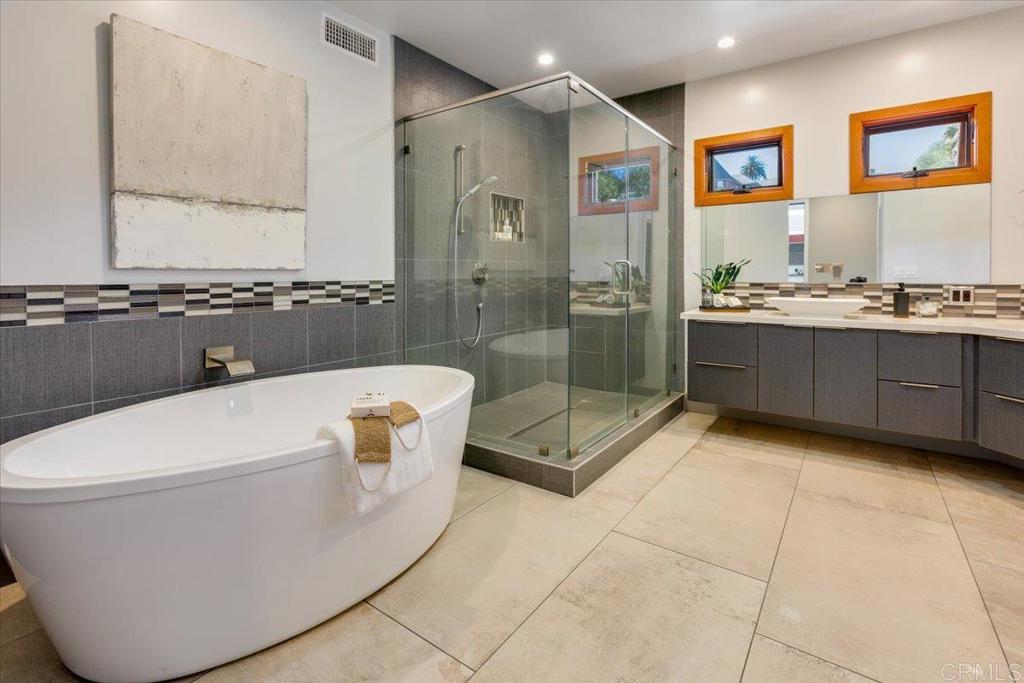 5382 Willman Way Fallbrook, CA 92028 - Photo 21 of 64 a bathroom with a granite countertop sink a toilet and bathtub