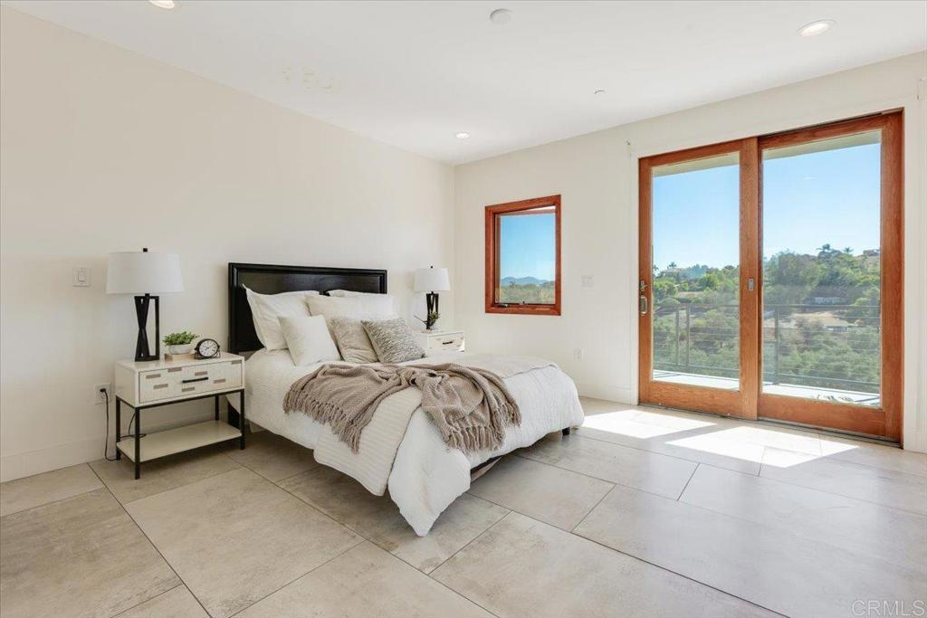 5382 Willman Way Fallbrook, CA 92028 - Photo 24 of 64 a spacious bedroom with a large bed and a large window