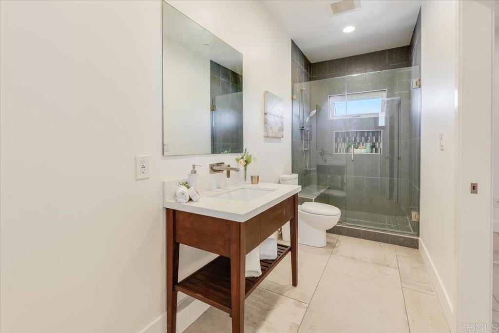 5382 Willman Way Fallbrook, CA 92028 - Photo 28 of 64 a bathroom with a sink a toilet and shower