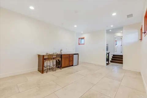 a view of a house with couches and a table