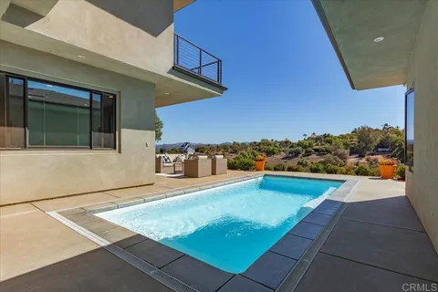 an aerial view of a house with a swimming pool