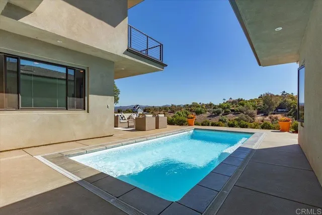 an aerial view of a house with a swimming pool