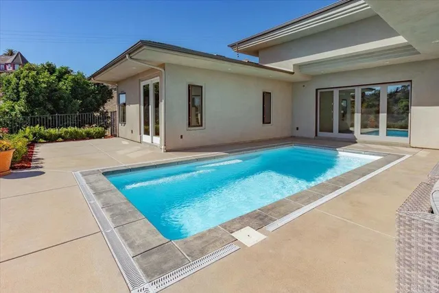 an aerial view of a house with a yard and a large tree