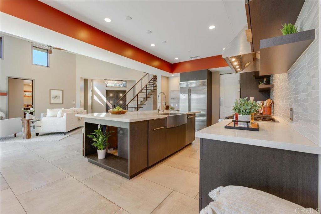 5382 Willman Way Fallbrook, CA 92028 - Photo 9 of 64 a spacious kitchen with stainless steel appliances kitchen island granite countertop a sink and cabinets