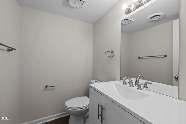 a bathroom with a sink toilet and a mirror