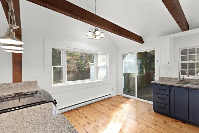 a view of a kitchen with a sink and a large window