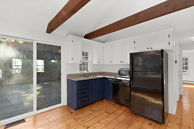 a kitchen with granite countertop stainless steel appliances and refrigerator