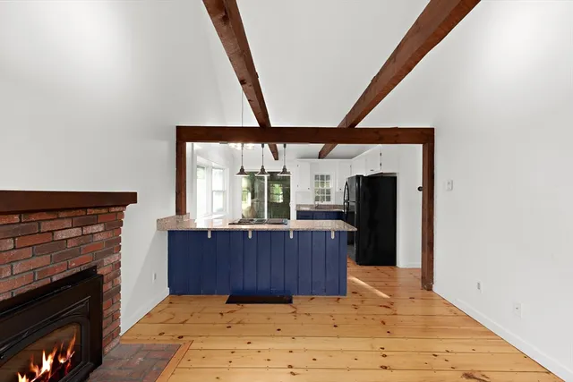 a view of kitchen with furniture and fireplace