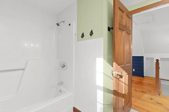 a bathroom with a bathtub and a shower