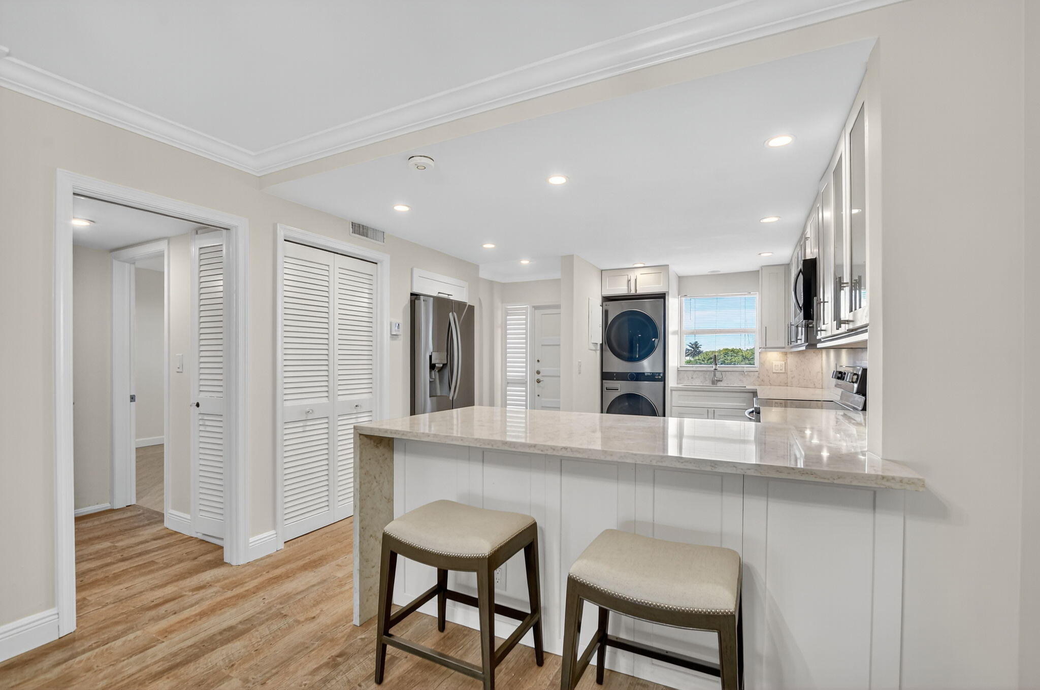 1040 Banyan Road, Unit 3050 Boca Raton, FL 33432 - Photo 14 of 35 a kitchen with stainless steel appliances granite countertop a sink and a refrigerator
