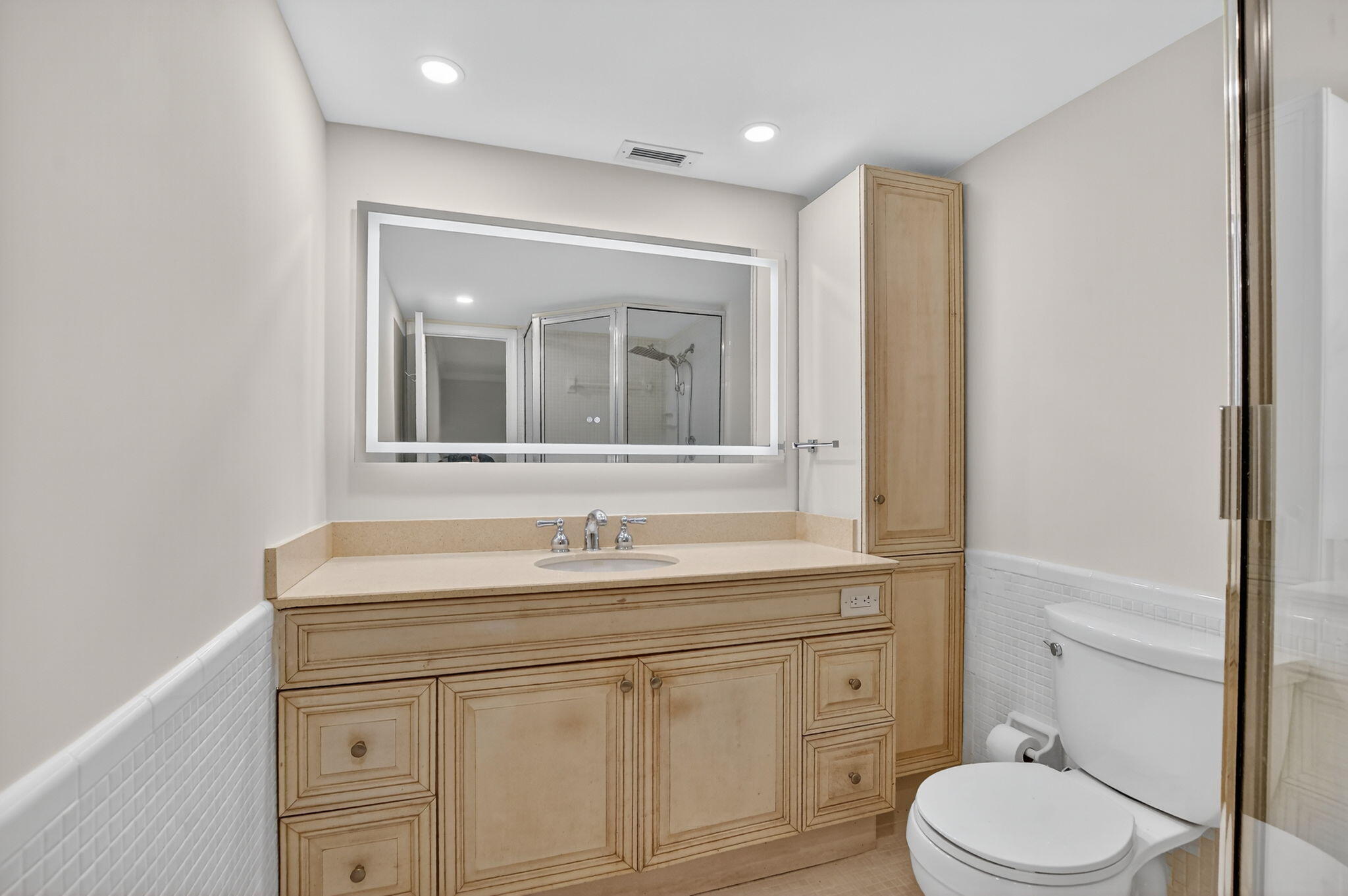1040 Banyan Road, Unit 3050 Boca Raton, FL 33432 - Photo 21 of 35 a bathroom with a sink vanity mirror and toilet