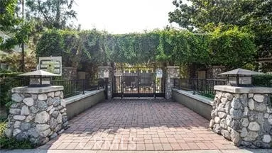 a view of a pathway with a wrought fence