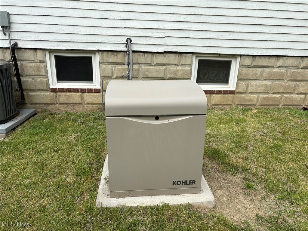 1726 Lincoln Road Wickliffe, OH 44092 - Photo 3 of 9 Exterior view of a power unit, a wood stove, and cooling unit