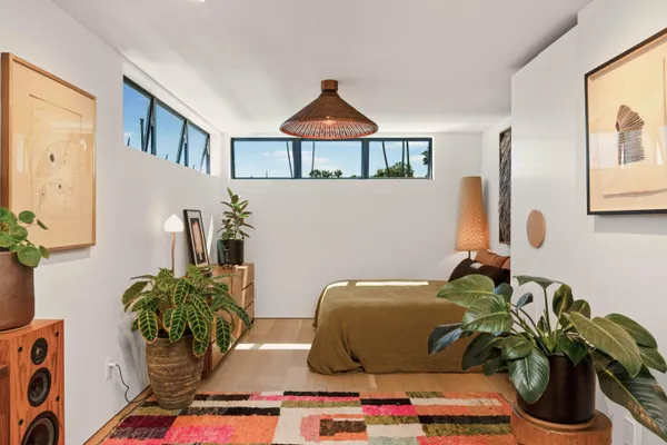 a living room with furniture and flowers