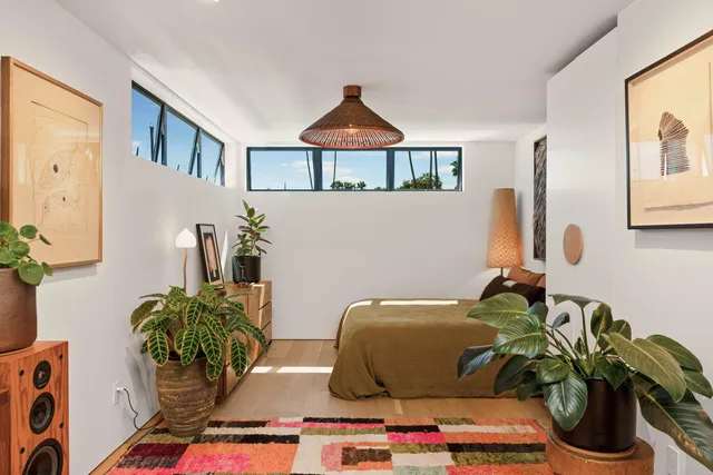 a living room with furniture and flowers