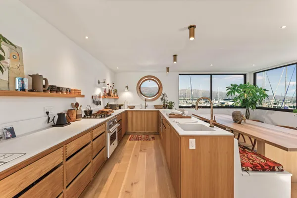 a large kitchen with stainless steel appliances a large window in it