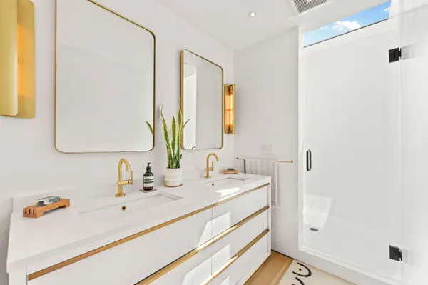 a bathroom with a double vanity sink mirror and
