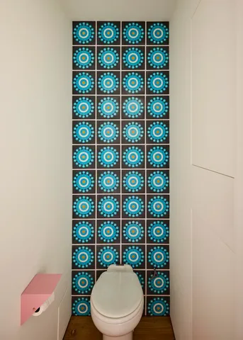 a white toilet sitting next to a window