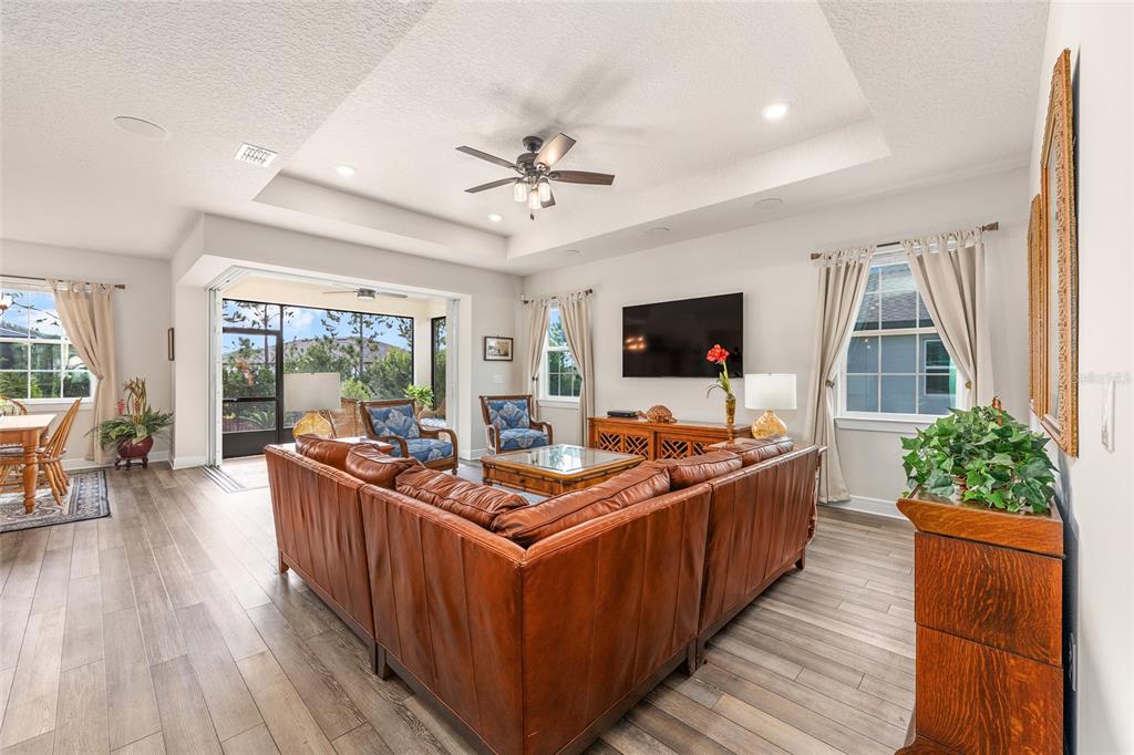 8986 Southwest 58th Street Road Ocala, FL 34481 - Photo 11 of 53 a living room with furniture and a flat screen tv
