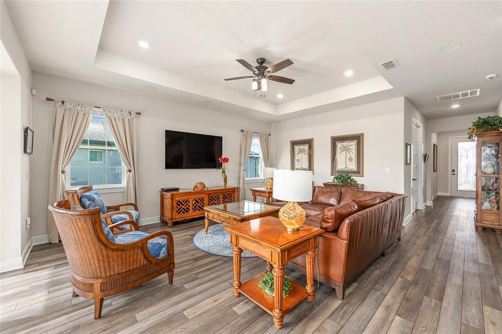 8986 Southwest 58th Street Road Ocala, FL 34481 - Photo 12 of 53 a living room with furniture flat screen tv and wooden floor