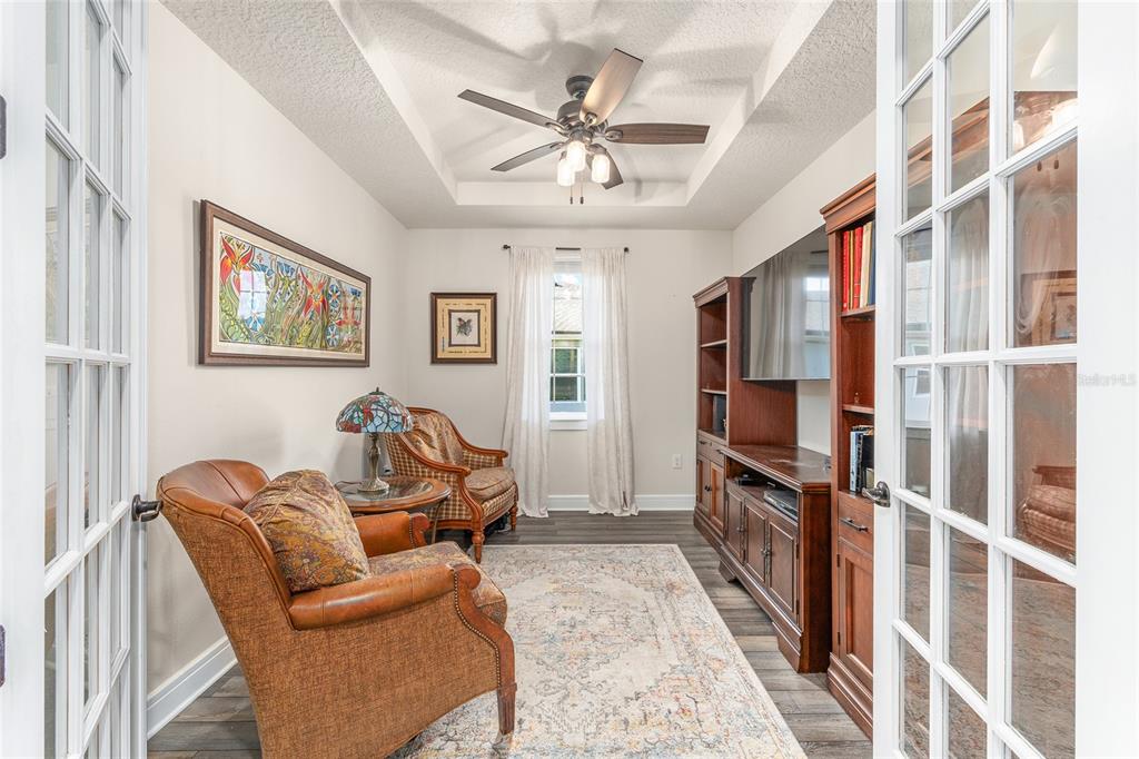 8986 Southwest 58th Street Road Ocala, FL 34481 - Photo 21 of 53 a living room with furniture a flat screen tv and a window
