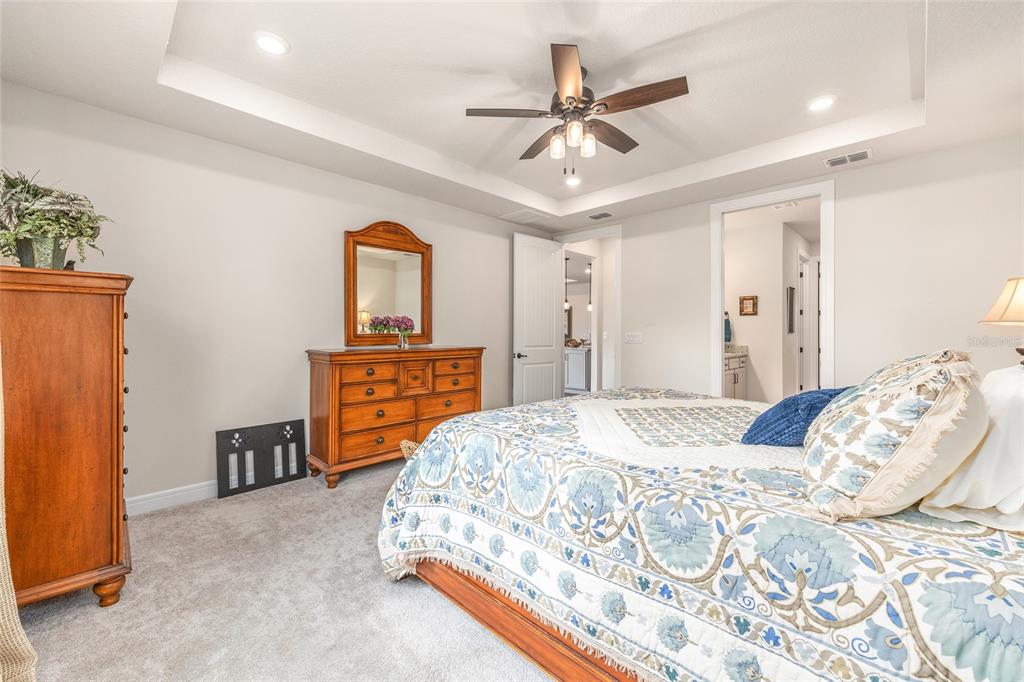 8986 Southwest 58th Street Road Ocala, FL 34481 - Photo 24 of 53 a bedroom with a bed and a chandelier