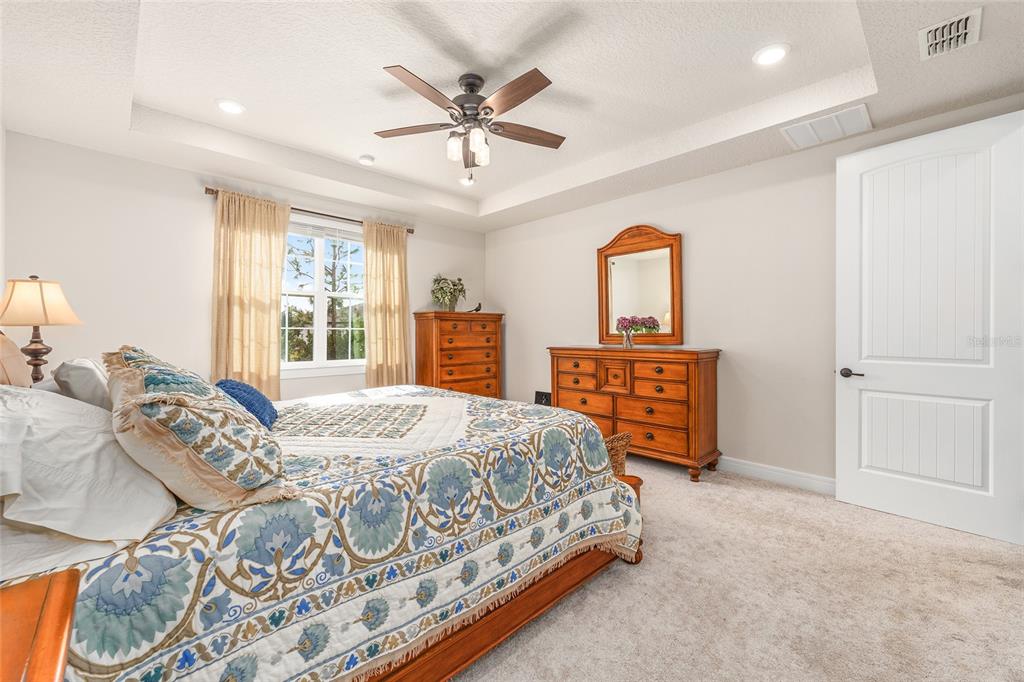 8986 Southwest 58th Street Road Ocala, FL 34481 - Photo 25 of 53 a bedroom with a bed a dresser and window