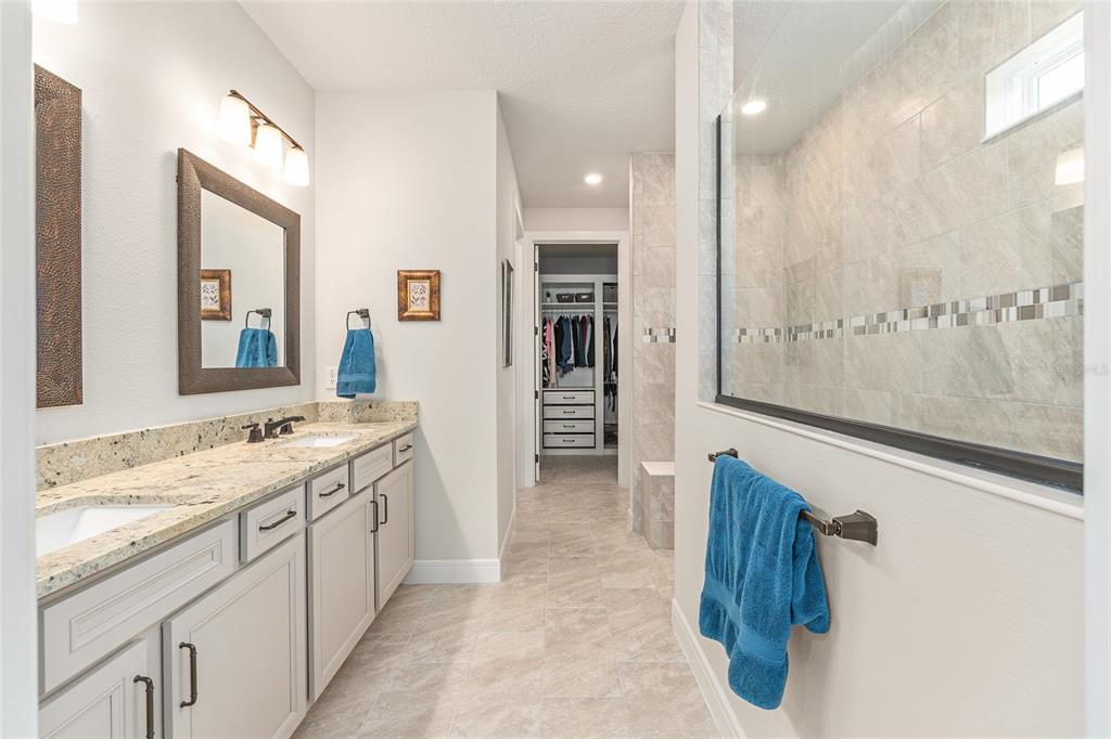8986 Southwest 58th Street Road Ocala, FL 34481 - Photo 26 of 53 a spacious bathroom with a granite countertop sink mirror and a