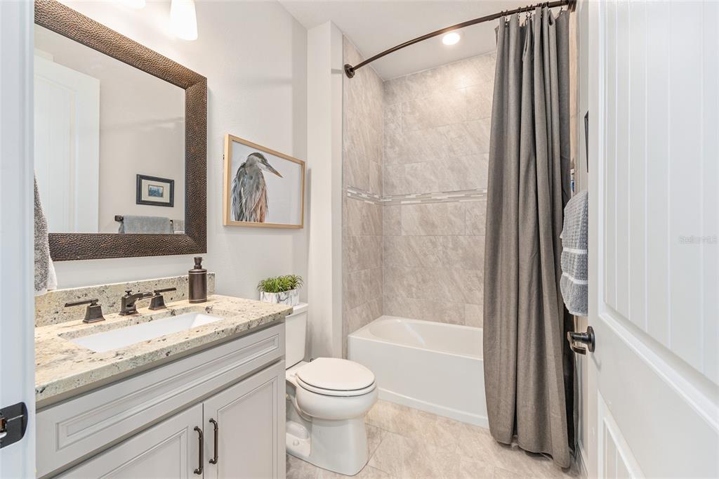8986 Southwest 58th Street Road Ocala, FL 34481 - Photo 29 of 53 a bathroom with a granite countertop sink toilet and shower